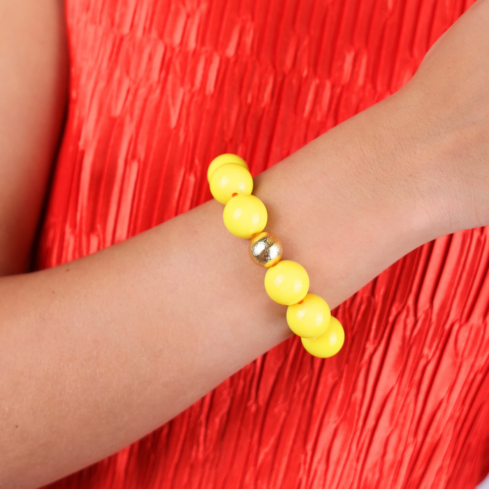 a yellow beaded bracelet on a person's wrist