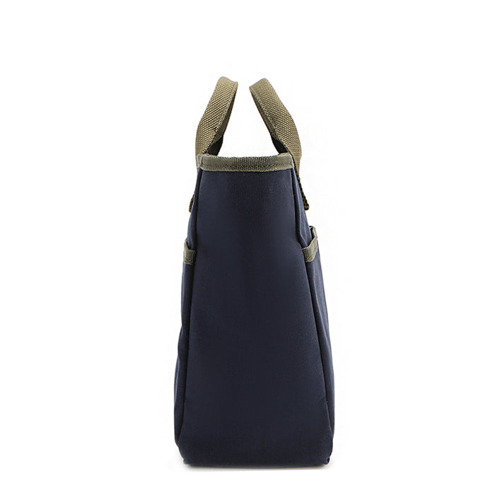 Slim yet spacious side silhouette of the Nodu Nadu Emery bag in classic navy blue with moss green trim and straps. Front and back slip pockets allow you to store your most-used items. A rectangular silhouette evokes a sense of classic style and timelessness.