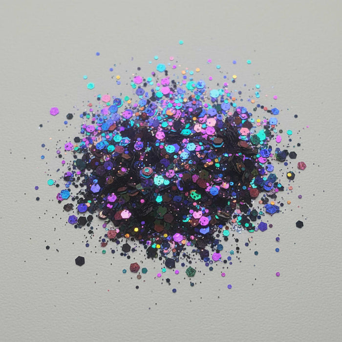 Color shifting glitter explosion on a gray background
