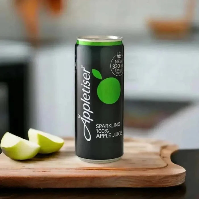 Appletiser 300ml can beside sliced green apple