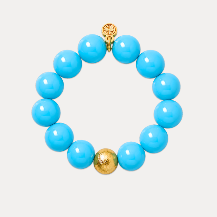 a blue beaded bracelet with a gold bead