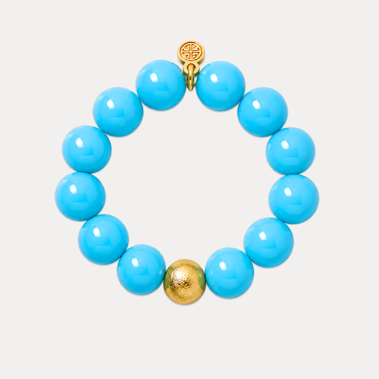a blue beaded bracelet with a gold bead