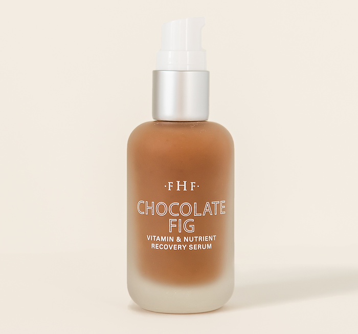 Bottle of Chocolate Fig Vitamin Recovery Serum | Farmhouse Fresh with frosted glass and pump dispenser, showcasing rich brown serum for skincare and wellness routines.
