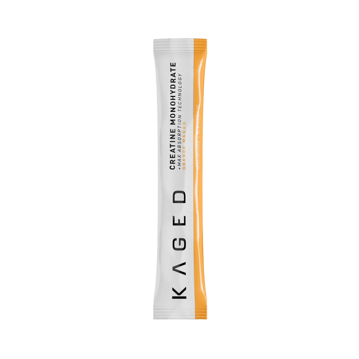 Close-up of creatine monohydrate stick pack showing the label Creatine Monohydrate - Orange Mango and an orange side stripe on black background #flavor_orange mango