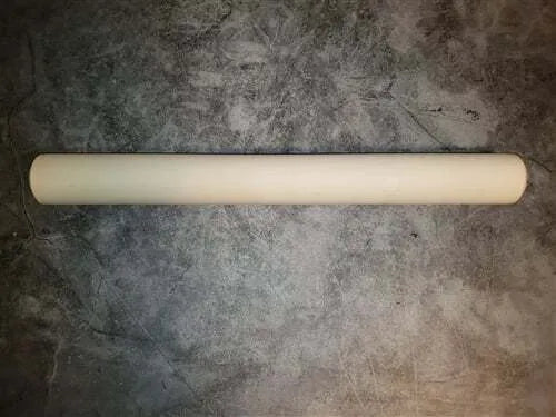 A beige, solid-colored dowel rolling pin on a light background.