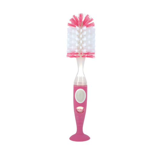 The Easy Clean Soap Dispensing Brush with Suction Base features a pink and white design, wide bristled head, textured handle, and suction base for stable cleaning of baby bottles.