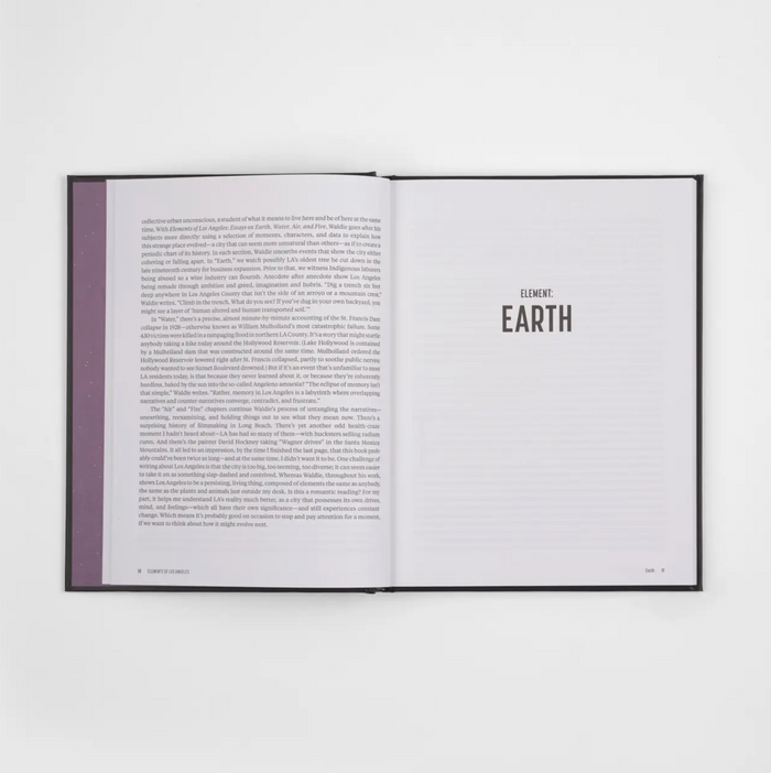 Open interior pages with 'EARTH' section title and paragraphs of text on right
