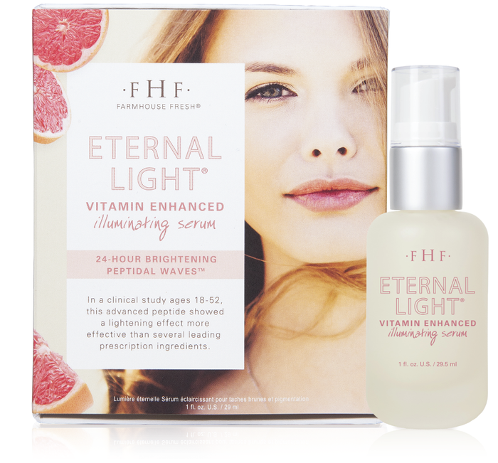 Eternal Light® Vitamin Enhanced Illuminating Serum | Farmhouse Fresh bottle next to packaging featuring a woman's face and grapefruit slices, highlighting skincare and brightening benefits.