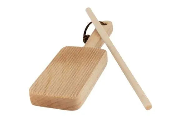 A wooden gnocchi paddle with a flat rectangular board and a long handle, alongside a wooden rolling pin, displayed against a white background.