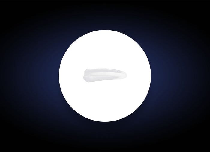 Close-up of a smooth, translucent swatch of Ideal Complex¨ Revitalizing Eye Gel | PCA Skin on a white circular background, highlighting its lightweight skincare texture.