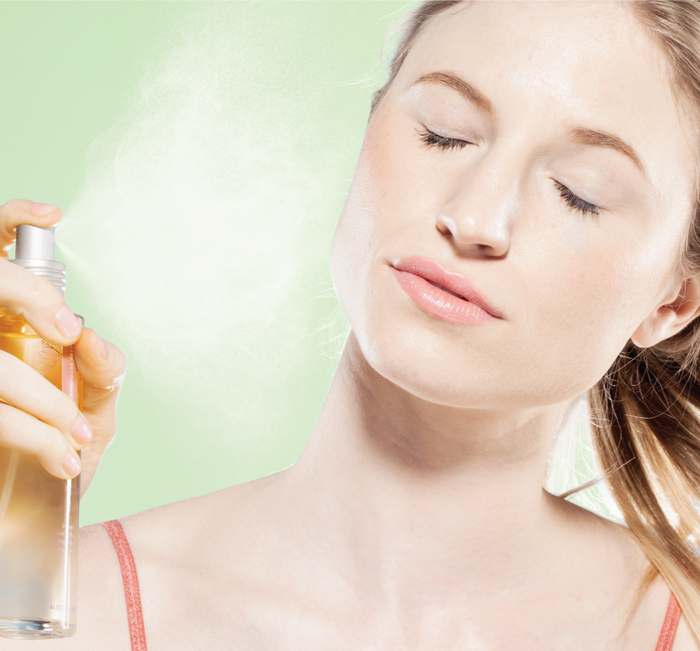 Woman with closed eyes gently spraying a mist of Illumination Juice® Facial Tonic – Illuminating Facial Toner | Farmhouse Fresh on her face for skincare and a radiant glow.
