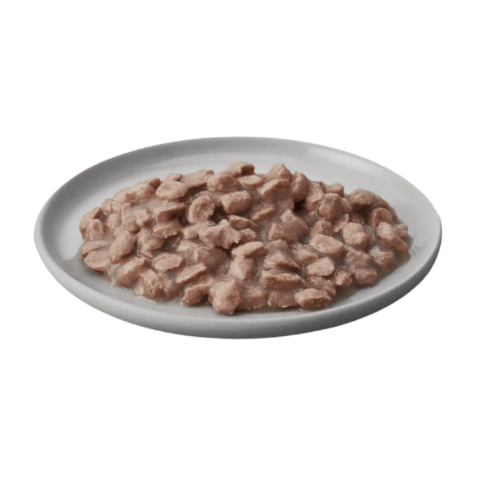 White background with a white bowl pictured filled with wet adult cat food.