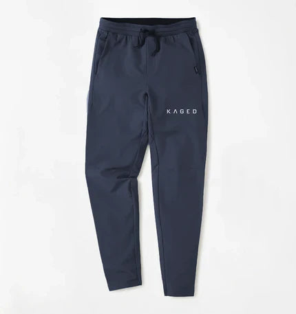 Front view of Kaged x UNRL Apex Training Pants in navy, tapered fit with drawstring waist and side pockets on white background #color_navy