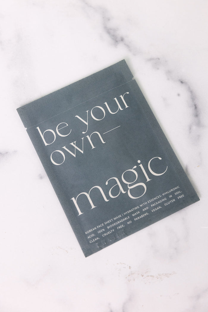 Korean Sheet Mask - Be Your Own Magic | Lucky Owl in minimalistic dark gray packaging with white elegant text, promoting clean, cruelty-free skincare on a marble surface.