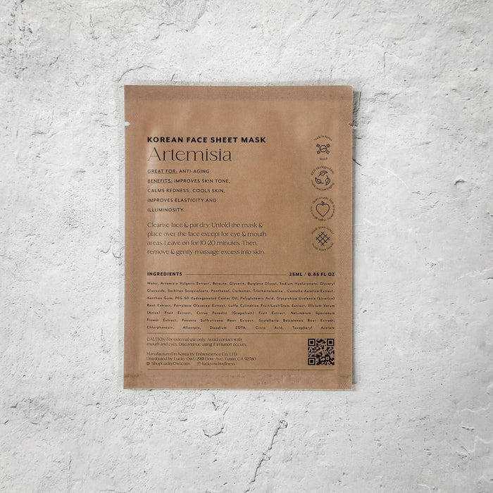 Back view of a Korean Sheet Mask - You Deserve a Break | Lucky Owl in kraft paper packaging, highlighting ingredients, usage instructions, and skincare benefits for anti-aging and skin tone improvement.