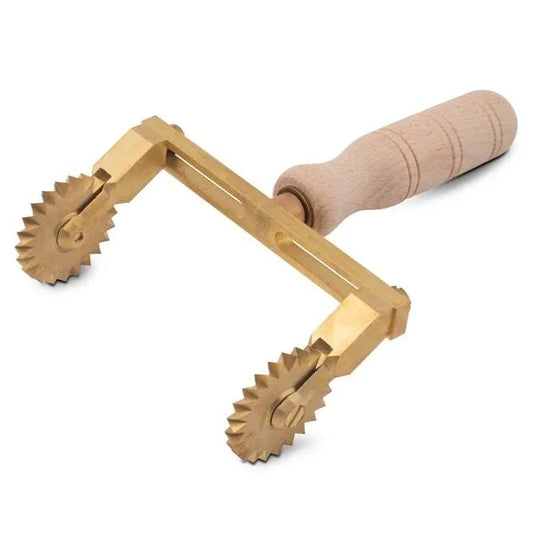 A professional adjustable pasta cutter with two fluted wheels made of brass and a natural wood handle.