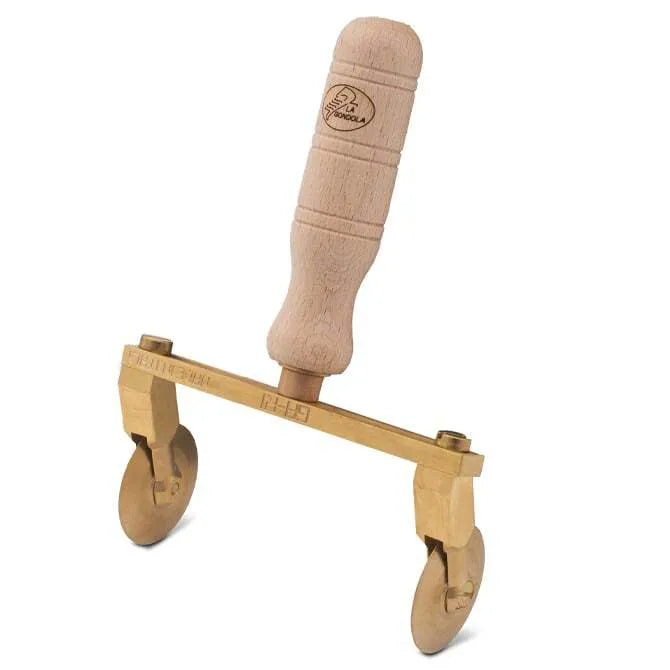 A professional adjustable ravioli cutter with two smooth wheels made of brass and a natural wood handle.