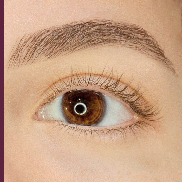 Close-up of a brown eye showing a before and after effect of Lash Extension Tubing Mascara | Blinc that enhances and defines natural eyelashes with a dark black finish.