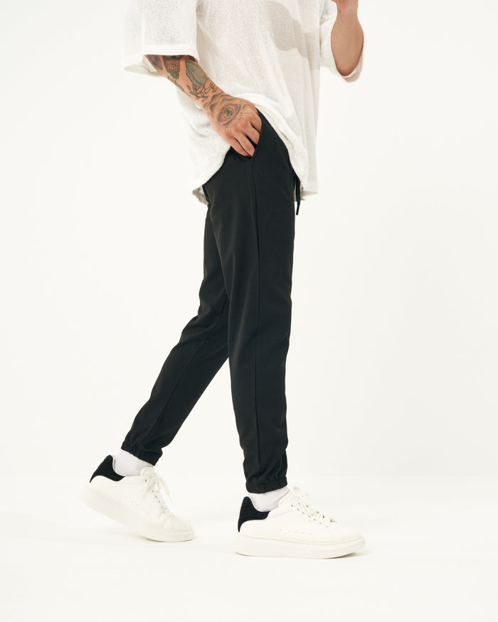 Martin Valen men's slim casual jogger in black, side mid-shot showing hand pocket and elasticated ankle