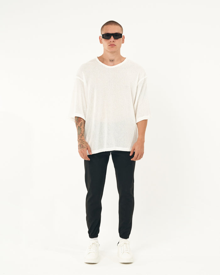 Martin Valen men's slim jogger in black, rear leg view with elastic cuffs and visible black-heeled sneakers