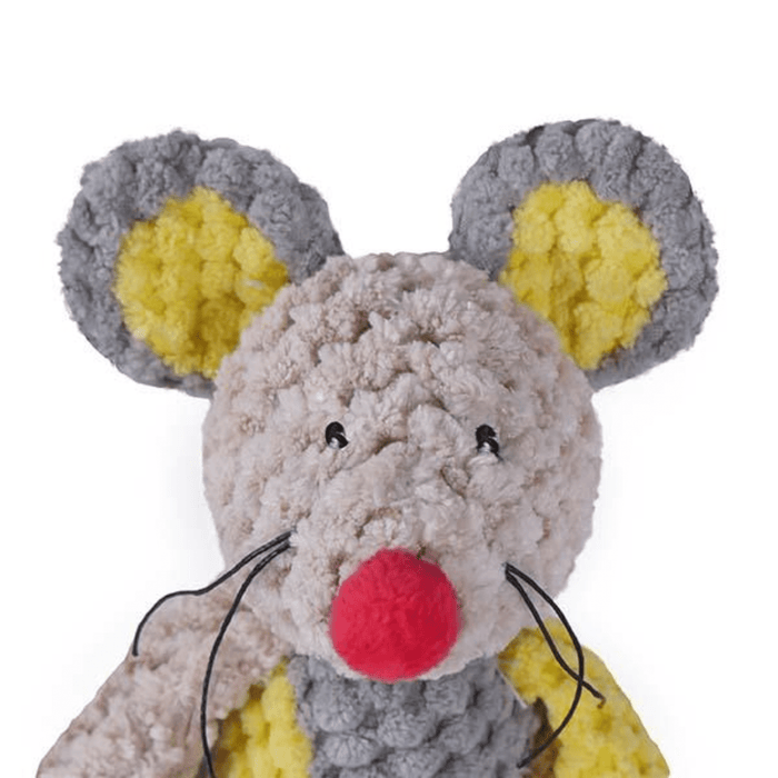 Patchwork Mouse Dog Toy with pale grey face with a red nose and stitched eye details, with string whiskers. Yellow inner ear with dark grey outer. Dark grey body with yellow and brown patches pictured on a white background.
