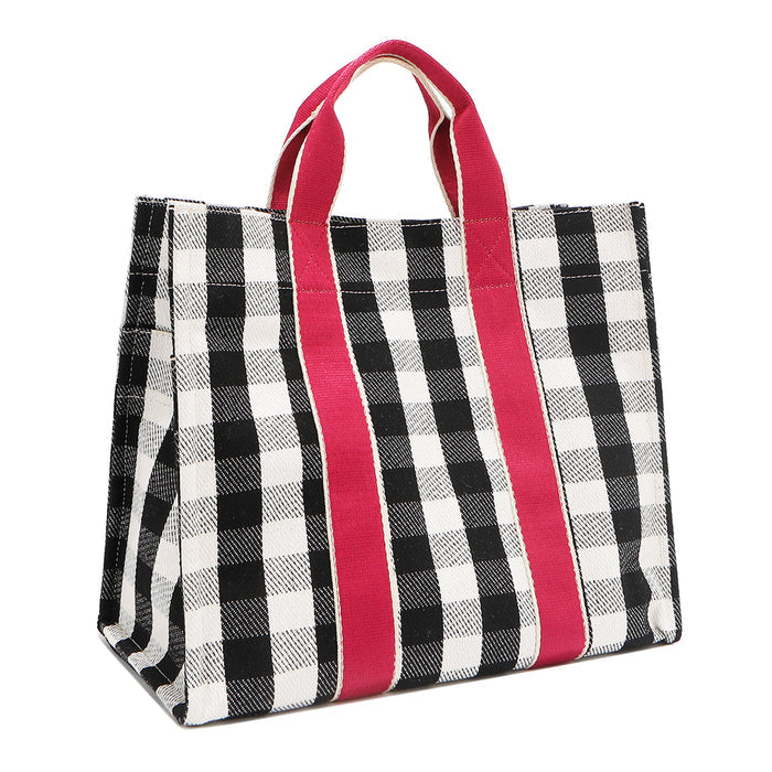 Back angled view of the Nodu Nadu Canvas Blair Bag – highlighting structure and woven texture in black and white and side panel with open slip pocket.