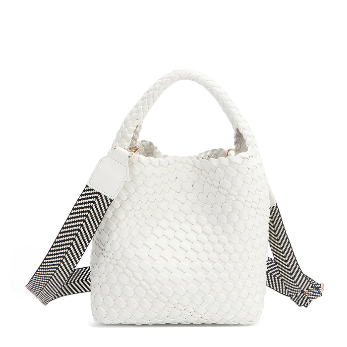Introducing Juni from Nodu Nadu by Nicole Lee, a versatile and slouchy chic handbag with a removable pouch inside. Crafted in braided vegan leather with an optional, adjustable chevron striped shoulder strap for varied carrying options so you can wear it across the body or by the top handle for a sleek look. Pictured in a classic, timeless white shade with a black and white tonal striped shoulder strap.