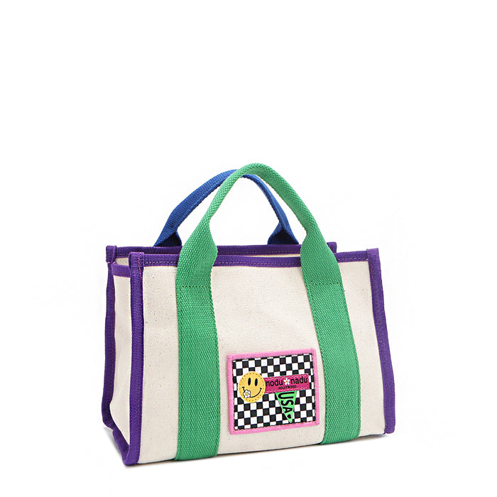 Front angle of the small Rowan polyester bag with mix-and-match straps—because your style deserves options! Available in classic beige with grass green and bold purple accents and a checker print smiley face adorned embroidered logo patch on the front.