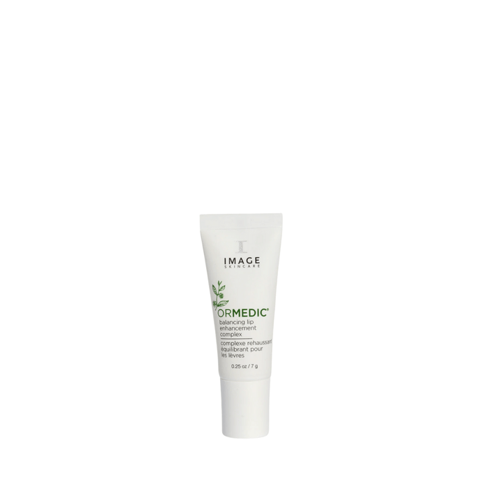 White tube of ORMEDIC lip enhancement complex | IMAGE Skincare with green text and plant design on the label, promoting skincare and wellness.