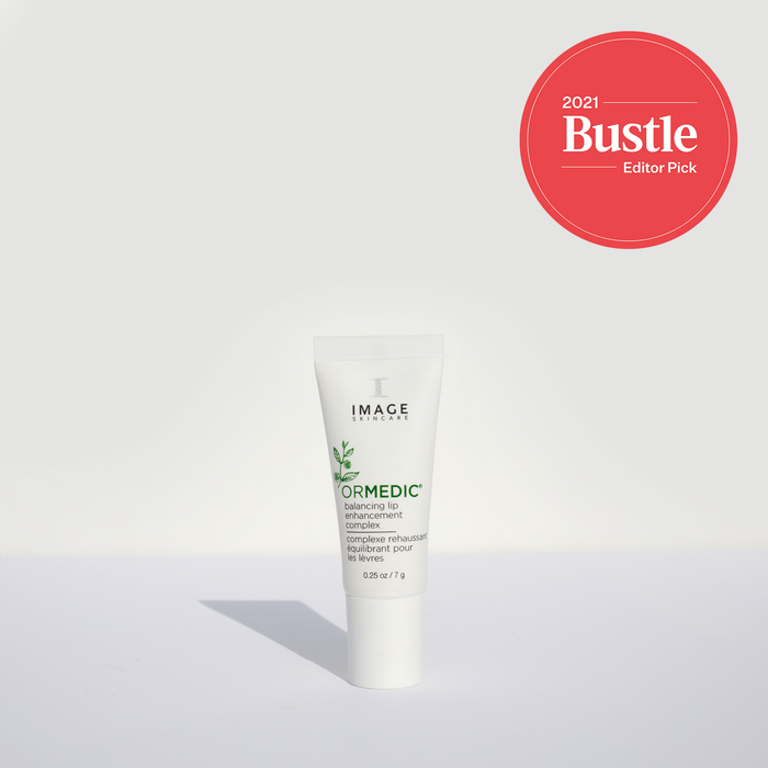 Tube of ORMEDIC lip enhancement complex | IMAGE Skincare with a red 2021 Bustle Editor’s Pick badge above it on a plain light background