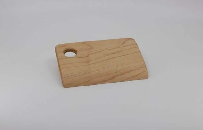 Wooden pasta board set showing smooth board with finger hole on white background.