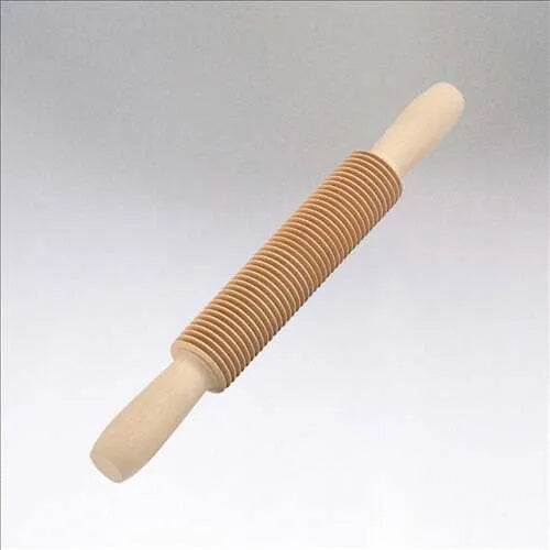 A wooden pasta cutter with a rolling pin shape designed for cutting spaghetti from rolled-out pasta dough.