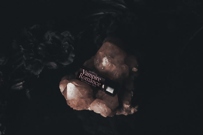 Vampire Romance perfume bottle on a decorative stone with dark background