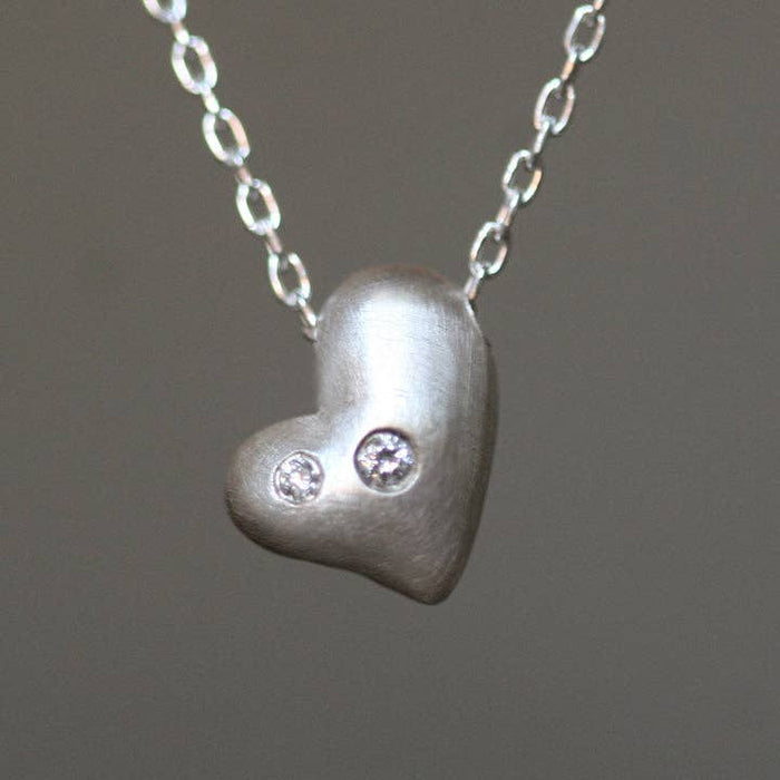 Sterling silver heart pendant necklace with three round diamond accents