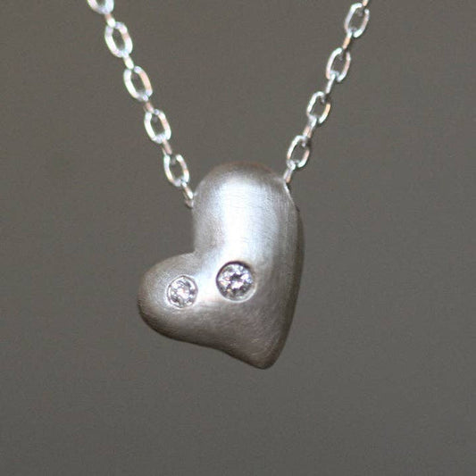 Sterling silver heart pendant necklace with three round diamond accents