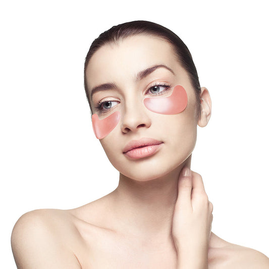 Woman with smooth skin wearing Rose Quartz Antioxidant Eye Mask - 6 Pack | Knesko under her eyes, promoting skincare and wellness recovery.