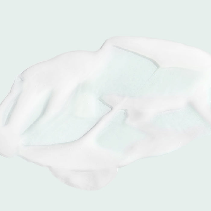Close-up of white creamy texture of the MAX™ serum | IMAGE Skincare on a light background, highlighting its smooth and rich consistency for skincare use.