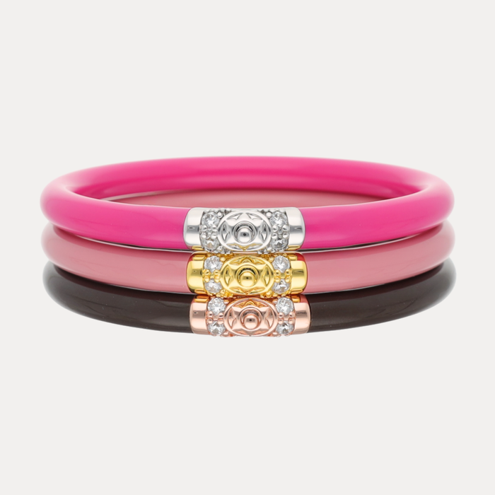 The Pink Tidal Luxe Stack featuring three stylish bracelets in pink, black, and gold embellishments.