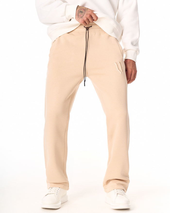 Martin Valen V‑Sharp beige jogger front waist view, black drawcord and embroidered side logo visible