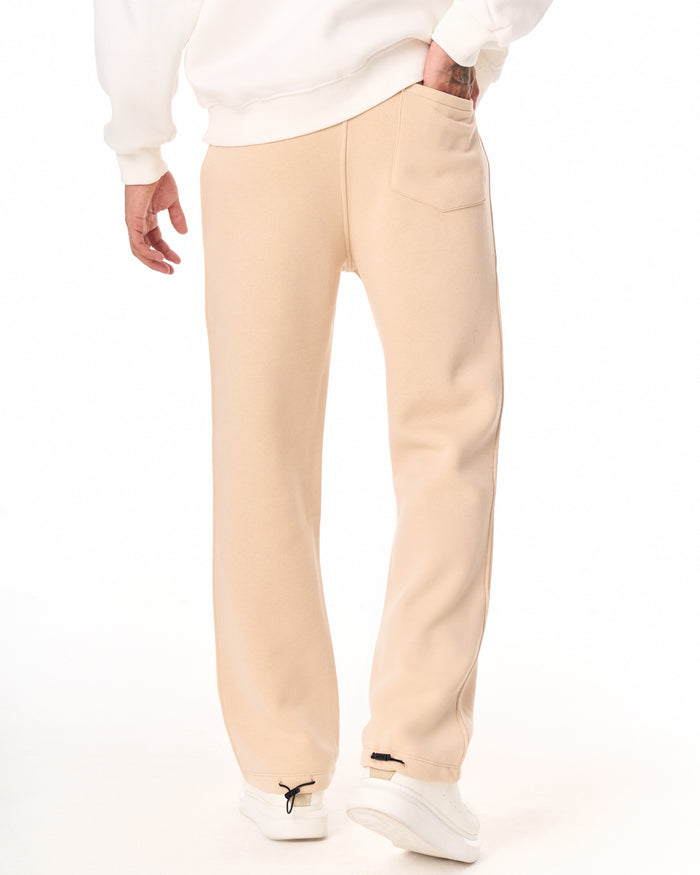 Martin Valen V‑Sharp oversized beige jogger, rear‑hip view showing back pocket and relaxed fit