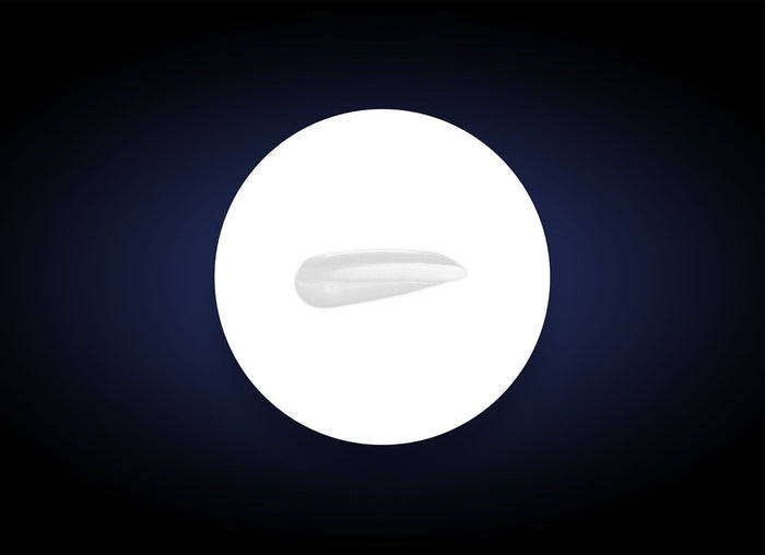 Close-up of a smooth white serum sample on a white circular background against a dark backdrop, showcasing the texture of Vitamin B3 Brightening Serum | PCA Skin for skincare use.