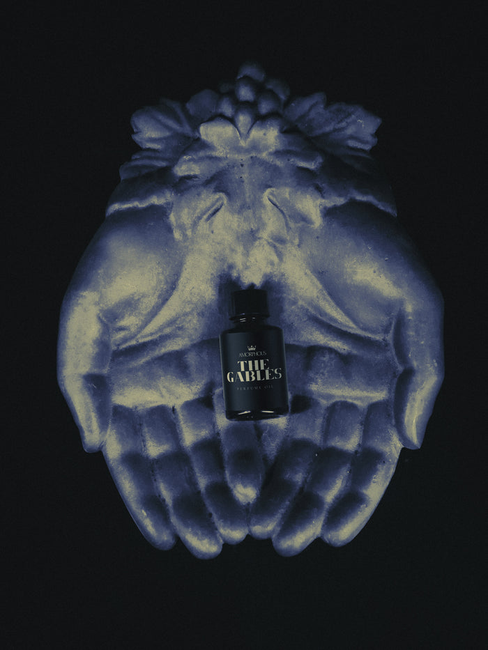Bottle of 'The Gables' on a decorative wall piece with blue and yellow patterns.