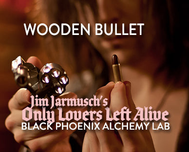 Wooden bullet prop with text overlay for 'Only Lovers Left Alive' and 'Black Phoenix Alchemy Lab'.